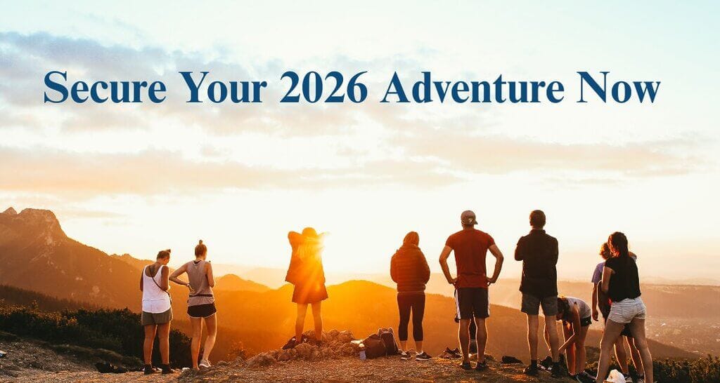 Group of hikers on a mountain watching sunset with Wonder Voyage blog title Secure Your 2026 Adventure Now
