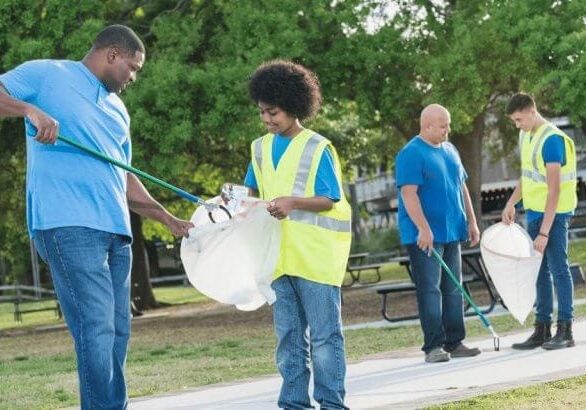 Group of people serving community by picking up trash